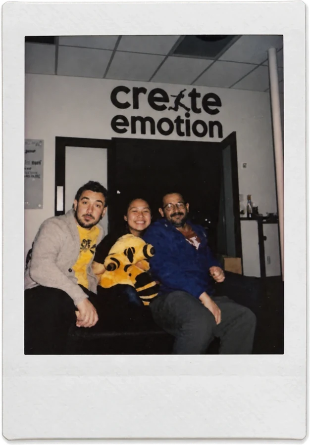 Three of the team under the Create Emotion sign